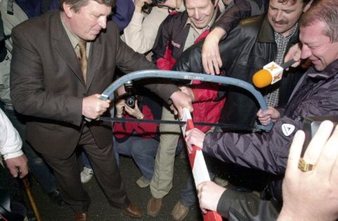 Deux maires découpent une barrière entre Pologne et Slovaquie le 1er mai 2004 - AFP