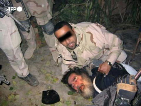 Unsourced photo of captured Saddam Hussein held by a US soldier - AFP