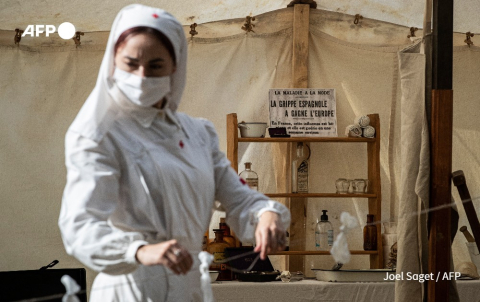 A French actress plays a nurse in a reconstruction of a Spanish flu-era tent hospital - Joel Saget - AFP