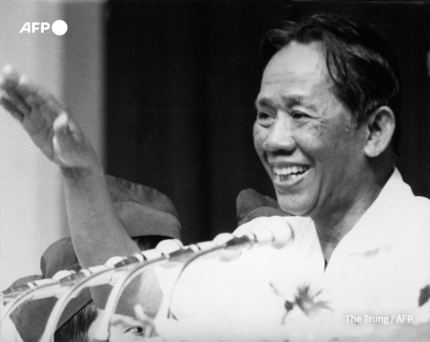 Le Duan, the first secretary of the VNWPCC (North Vietnam) waves to the crowd 15 May 1975 during a meeting celebrating the victory over South Vietnam and US forces. - AFP