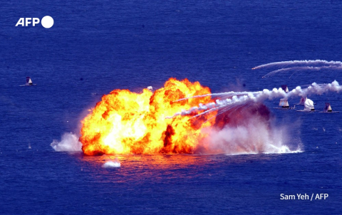 Taiwanese jets (not pictured) drop napalm bombs on mock targets at sea during a war exercise off Litzechien, northeastern Taiwan on September 4, 2003 - Sam Yeh - AFP
