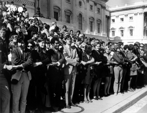 Anti-war demonstrators join hands before the United States Capitol Building on October 15, 1969 in Washington DC - AFP