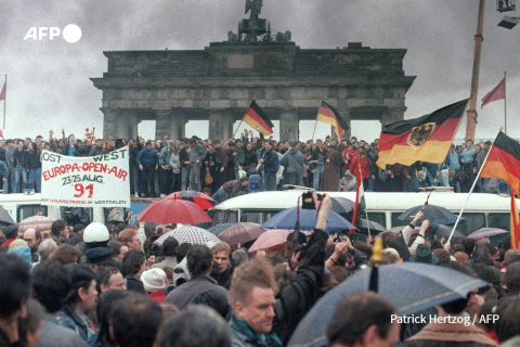 Des gens d'Allemagne de l'Est et d'Allemagne de l'Ouest se rassemblent pour l'ouverture de la porte de Brandebourg à Berlin le 22 décembre 1989. Patrick Hertzog - AFP