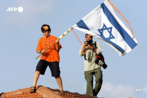 Colon israélien et photographe de l'AFP dans la bande de Gaza en août 2005 - Thomas Coex - AFP
